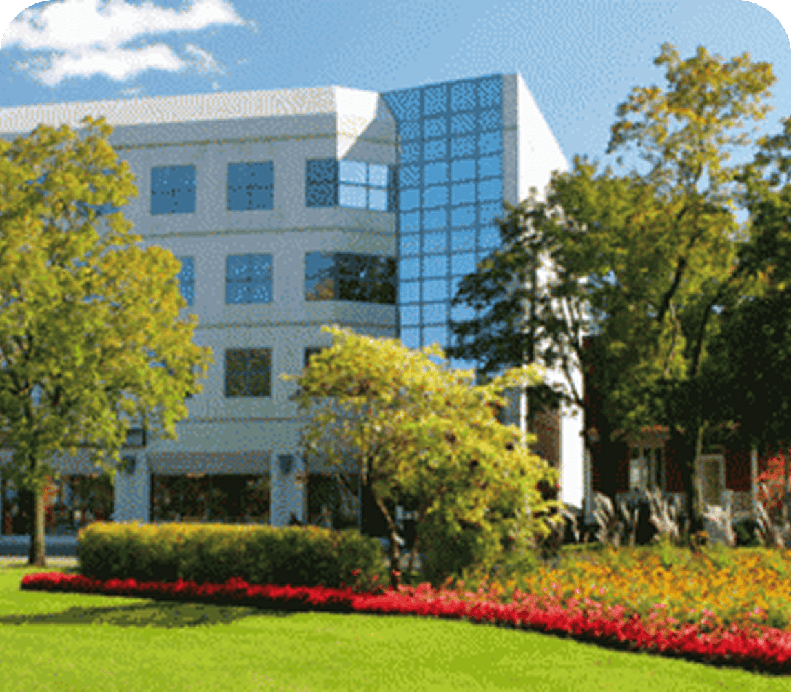 Modern building with trees and a garden.